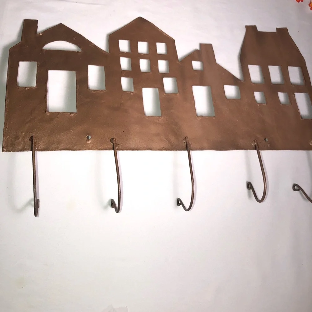 Copper painted metal house wall hanger with hooks, pre-owned